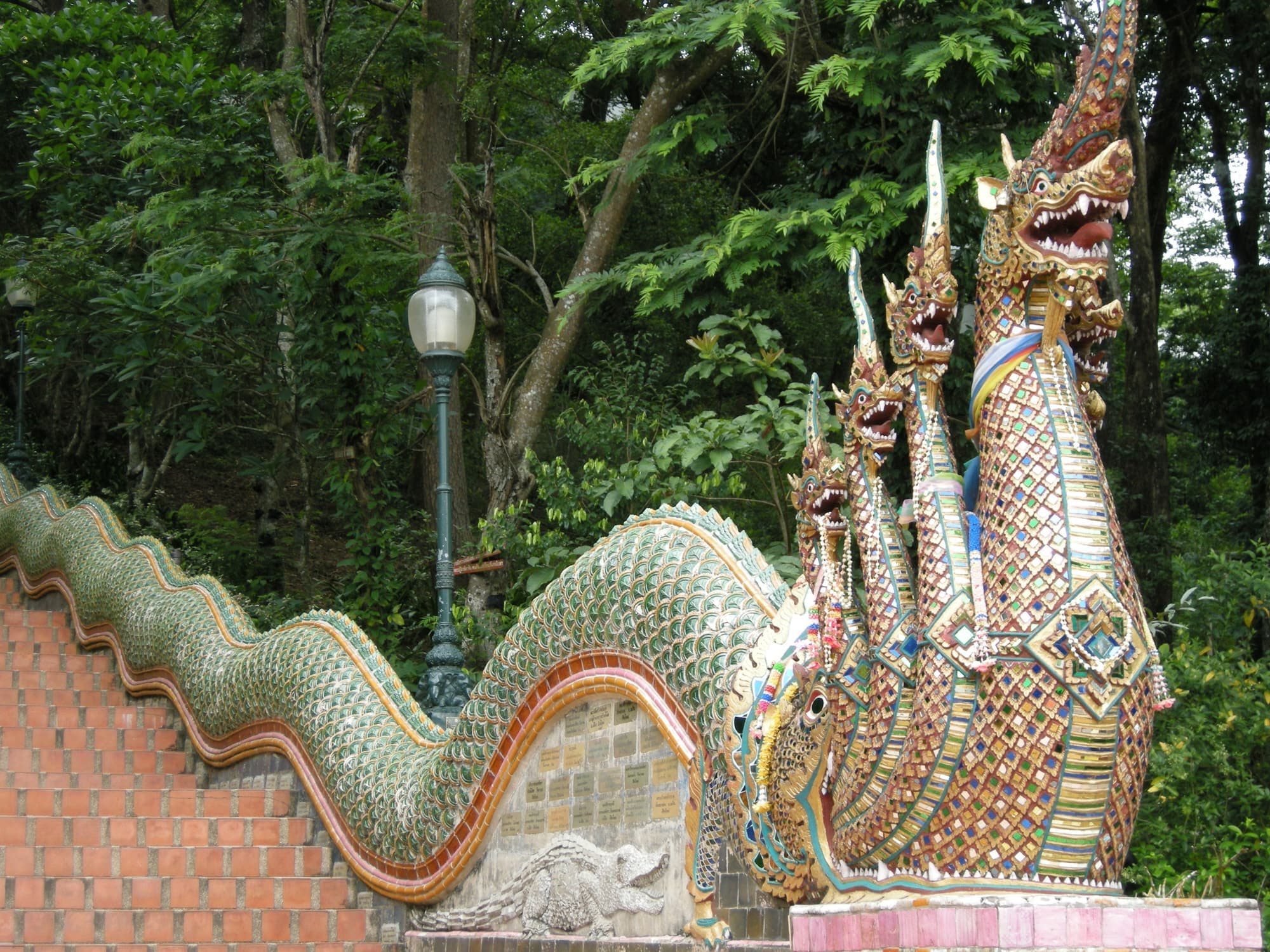 Mosaic Naga serpent heads guarding the stairs at Doi Suthep
