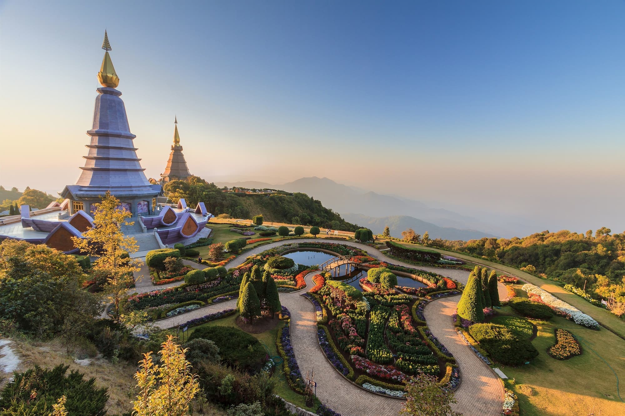 The King and Queen Pagodas on Doi Inthanon above flower gardens at golden hour
