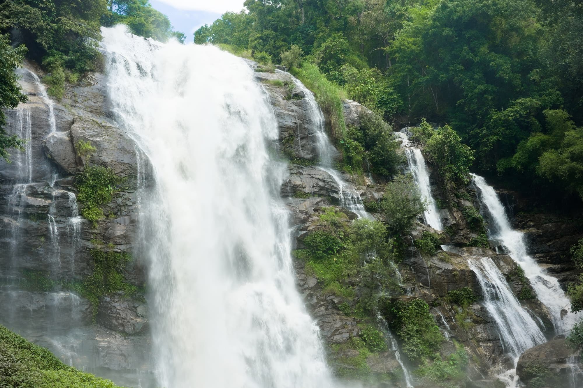 Wachirathan Waterfall pouring over dark granite in the forest