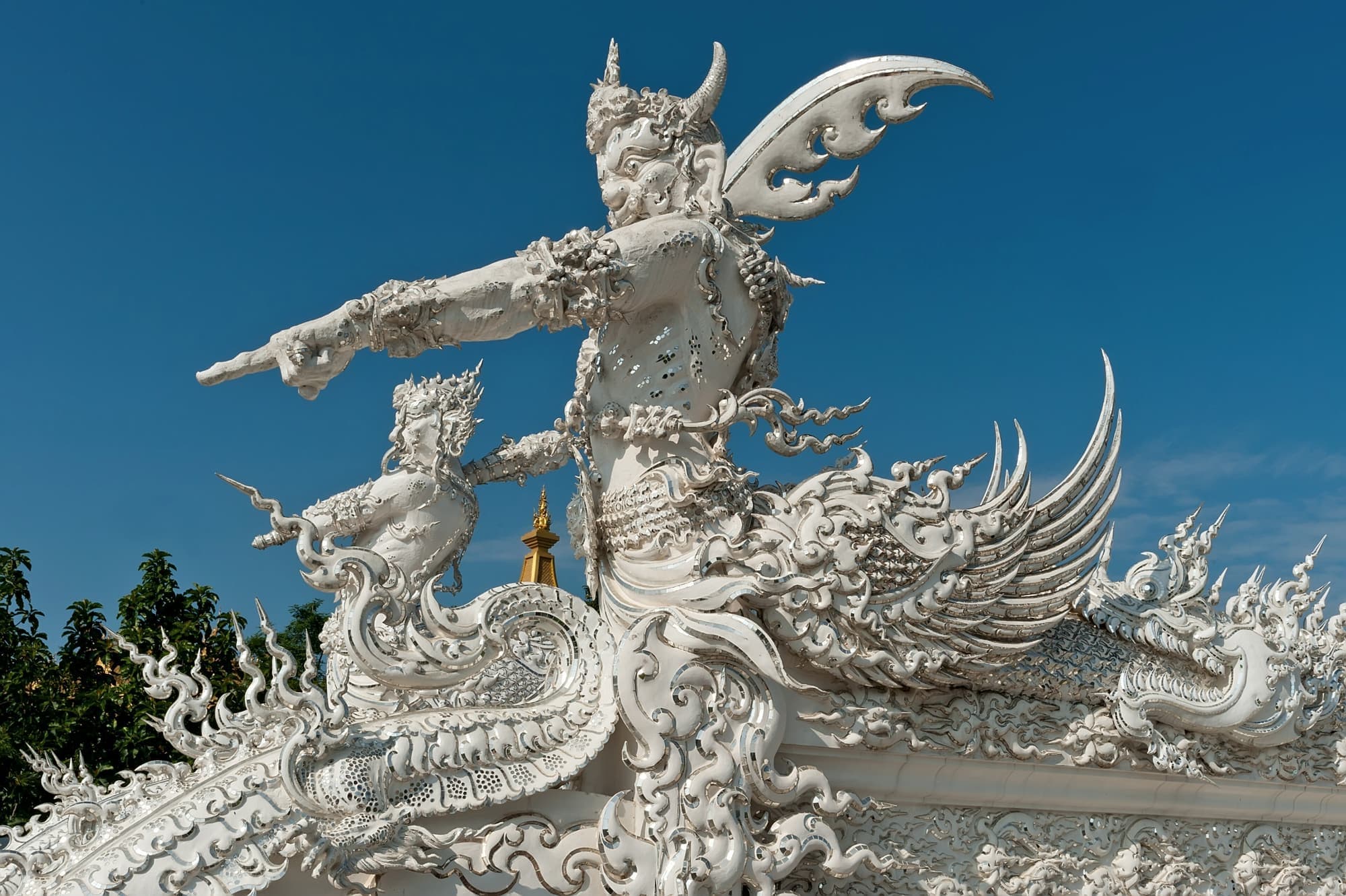 White guardian sculpture with a sword on the White Temple